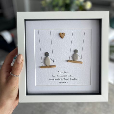 "☆ I have many other designs to choose from so be sure to check out my shop before ordering.  https://www.etsy.com/uk/shop/SherbetDesignsArt ☆ This artwork is handcrafted using natural pebbles and driftwood. Each art piece is made to order with your own personalised details which makes it a lovely gift for any occasion.  ☆ Please specify your wording in the personalised section when purchasing as all the text in the photos are just examples and do not come as standard. The exact wording on your order will be printed.  ☆ All pebble pictures are set in a 8\" x 8\" box frame with a glass front. It can be hung on a wall or placed to stand on a shelf or table. You can choose between a white, grey or light wood frame.  ☆ Please note the pebbles and driftwood will naturally differ to the photogra Rock Frames Stone Art, Pebble Rock Art, Sister Gifts Diy, Rock Crafts Diy, Pebble People, Rock People, Friendship Presents, Seashell Frame, Stone Artwork