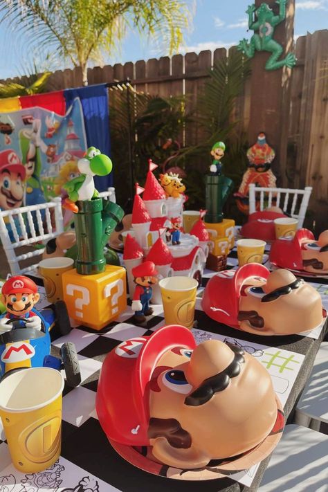 Take a look at this fantastic Super Mario-themed birthday party! The table settings are so much fun! See more party ideas and share yours at CatchMyParty.com Mario Party Centerpieces Ideas, Mario Kart Centerpiece Party Ideas, Mario Birthday Table Decor, Mario Table Decorations, Super Mario Table Decorations, Mario Birthday Party Centerpieces, Mario Party Table, Mario Bros Party Ideas Decoration, Super Mario Centerpieces