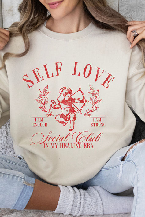 Get ready to be OBSESSED with your new favorite Self Love Social Club Sweatshirt. It's the cutest and most trendy way to emit all those Coquette Healing Era vibes! It is the perfect graphic sweatshirt to throw on all day every day! Crafted from the softest fabric, this Gildan 18000 sweatshirt ensures the utmost comfort throughout the day. Self Love Clothing, Social Club Aesthetic, In My Healing Era, Clothing Coquette, Comfy Sweatshirts, Coquette Clothing, Healing Era, Coquette Top, Club Aesthetic