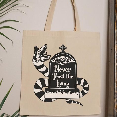 Available now! 🪲🖤🤍🪲🖤🤍 #beetlejuice #beetlejuice2 #shopsmall #shopsmallbusiness #smallbusiness #smallbusinesssupport #beetlejuicebeetlejuicebeetlejuice #beetlejuicebeetlejuice #nevertrusttheliving #strangeandunusual #imyselfamstrangeandunusual #sandworm #beetlejuicemerch Never Trust The Living, Strange And Unusual, Never Trust, Shop Small Business, Beetlejuice, Small Shop, Quick Saves