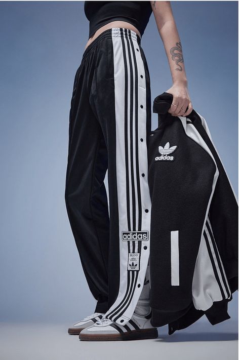 Make Your Daily Style Stand Out With These Women's Adibreak Track Pants From Adidas Originals. In A Black Colourway, These Mid-Rise Pants Are Made From Smooth Recycled Polyknit Fabric To Keep Them Lightweight. They Feature An Elasticated Waistband With A Drawcord Tie, While The Snap-Button Legs Offer A Verstaile Fit. With Secure Side Pockets For Your Essentials, These Pants Are Finished Off With The 3-Stripes And Retro Adidas Trefoil Branding. Machine Washable. | Our Model Is 5'6" Adidas Models Women, Adidas Side Button Pants Outfit, Sports Wear Womens Casual, Adibreak Pants Outfit Women, Y 3 Adidas, Pants With Buttons On Side, Adidas Clothes Women, Adidas Jogger Outfit, Adidas Track Pants Outfit Woman