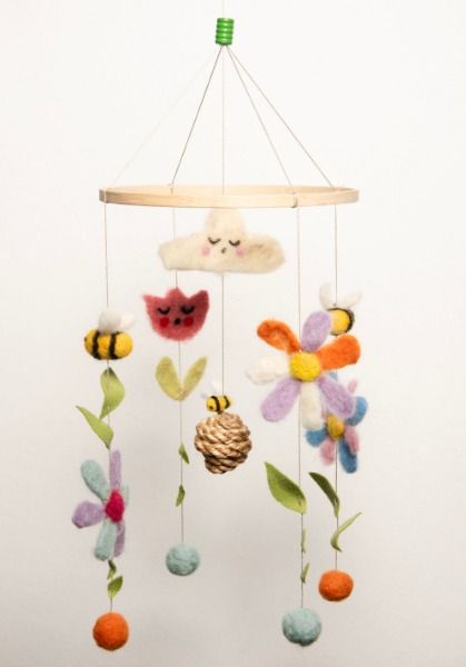 Spring is here

Bees and flowers play happily under the Ettmoln cloud and bring the atmosphere of the sunny season into your children's rooms.

This mobile is a toy for children and babies made of felt. Each mobile is made individually by hand in Cologne. 
The felt is made from 100% Merino sheep wool and the coloring is 100% non-toxic. Our felt manufacturer specializes in products for babies and children in daycare centers and schools. The cords are made of cotton. Bee Mobile, Felt Spring, Craft Stalls, Felt Hair Clips, Merino Sheep, Felt Mobile, Children Toys, Hanging Mobile, Craft Classes