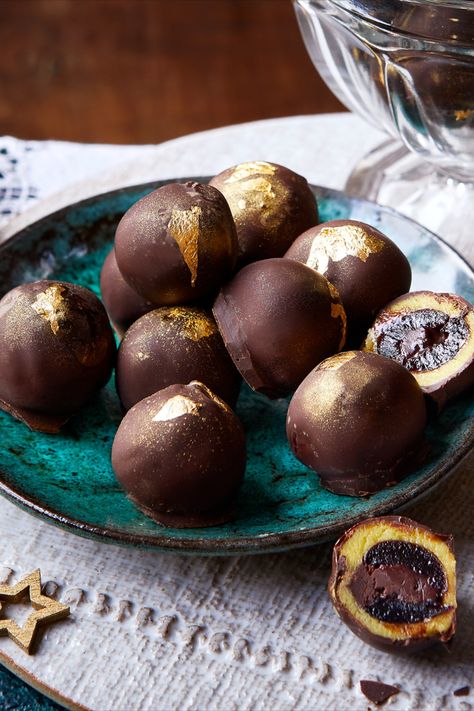 A plate of truffles, some cut open to reveal a chocolate stuffed cherry with a marzipan coating. Chocolate Cherry Truffles, Marzipan Chocolates, Holiday Confections, Cherry Truffles, Cherry Ganache, Truffles Christmas, Almond Truffles, Chocolate Business, Healthy Dark Chocolate