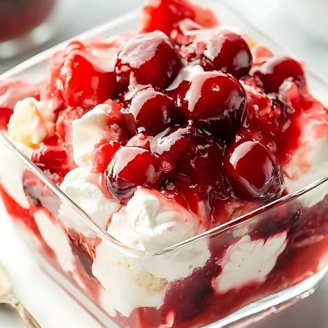 This recipe for cherries in the snow is heavenly! The combo of angel food cake, cream cheese, and cherries never fails to deliver. Cherries In Snow Dessert, Cherries In The Snow Recipe, Cherry Delight Dessert, Cherries In The Snow, Delight Dessert, Snow Recipe, No Bake Cherry Cheesecake, Cherry Delight, Fluff Desserts