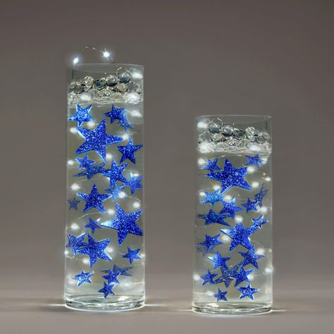 PRICES MAY VARY. Wow your guests with this festive and eye-catching magical illusion for centerpieces. For graduation centerpieces, weddings, anniversaries, holidays, birthdays, bridal showers, baby shower, unique gifts, and more.... Fills 1 gallon of the Floating Stars for your vases. Contains: 22 Glitter Stars and An Exclusive Measured Gels Floating Kit with Prep & Storage Bag, so no guessing and best results! The 22 Glitter Stars are resin, size range: 2" to 0.75". Easy to do. Can be prepared Star Wedding Centerpieces, Under The Stars Centerpieces, Vase Decorations, Stars Glitter, Mini Led Lights, Event Centerpiece, Light Images, Vase Fillers, Graduation Decorations