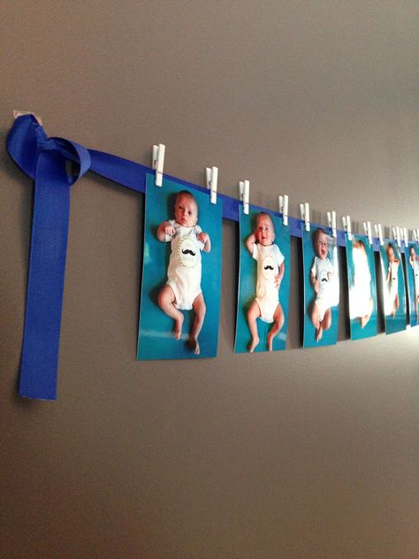 1st birthday - boy first birthday photo banner. Using ribbon, command hooks, and mini-clothes pins from the Party City baby shower section. Could also use baby shower or bridal shower pictures. Birthday Picture Banner, Baby Boy Birthday Decoration, Photo Banner First Birthday, Shower Pictures, Mr Onederful Birthday, Month Pictures, First Birthday Photo, Boy Birthday Decorations, City Baby