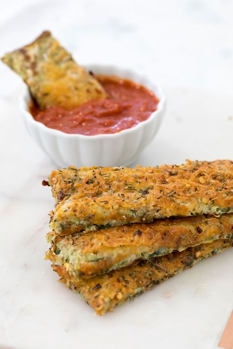 I created the recipe for these cheesy zucchini breadsticks when I was finishing my masters at NYU two years ago. It reminds me of the breadsticks we used to order from pizza places when I was younger, only much lighter! I have tried this recipe with organic wheat bran and pulverized GG crackers – both ways taste good! Dip the breadsticks with warmed up marinara sauce and enjoy! Cheesy Zucchini Breadsticks Serves 4 INGREDIENTS 3 medium zucchini, grated 4 GG crackers, pulverized or organic wheat Zucchini Crackers, Zucchini Breadsticks, Factor Recipes, Wasabi Mashed Potatoes, Gg Crackers, Low Calorie Appetizers, Low Carb Veggie, Breadsticks Recipe, Low Carb Marinara