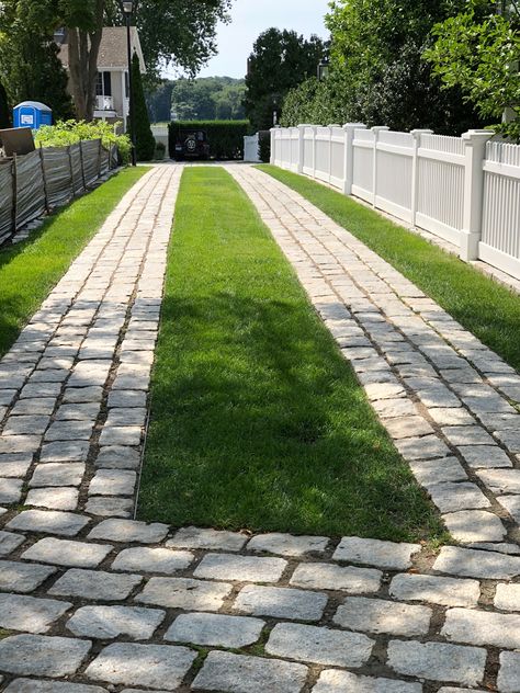 Beautiful and exceptionally done cobble stone and grass driveway in Essex, Connecticut. Mondo Grass Driveway, Stone And Grass Driveway, Brick Grass Driveway, Two Track Driveway, Concrete Grass Driveway, Concrete And Turf Driveway, Uphill Driveway Ideas, Driveway With Grass In Between, Grass Driveway Ideas