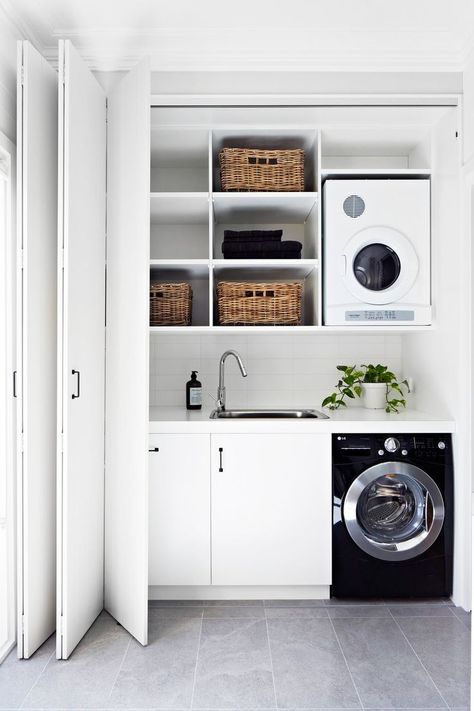 I like having a sink and how the doors close around the space so it isn't visible. European Laundry, Laundry Cupboard, Apartemen Studio, Laundry Nook, White Laundry, Laundry Design, Laundry Room Remodel, Laundry Closet, Melbourne House