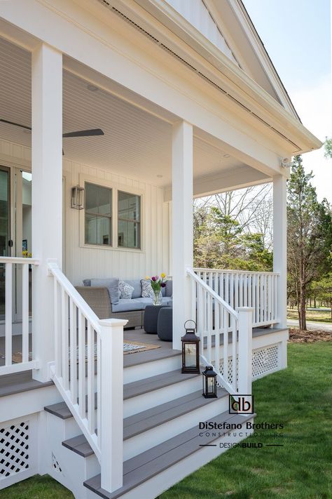 Designing and building decks is one of our specialties. This one features Azek composite decking, Timbertech railings, beaded shiplap ceilings and latticework. Front Porch Railings Farmhouse, Flat Roof Front Porch, Front Porch With White Railing, Front Porch With Composite Decking, Porch With White Railing, Composite Front Porch, White Front Porch Railing, Deck White Railing, White Deck Railing