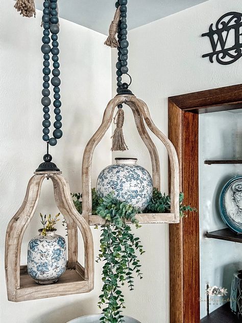 14 Best Decorations That Hang From Your Ceiling Hanging Decor Ideas From Ceiling, Rustic Hanging Decor, Hanging Items From Ceiling, Hanging Decor Ceiling, Wood Lantern Decor Ideas, Boho Hanging Candle Holders, What To Hang From Ceiling, Corner Hanging Decor, Boho Ceiling Hanging Decor