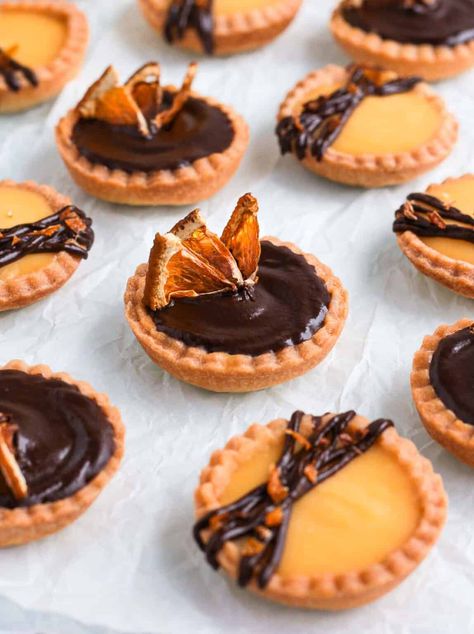 These Chocolate Orange Tartlets combine some homemade tartlet shells, an orange curd filling and a dark chocolate ganache topping. These mini chocolate orange tarts are the perfect mini dessert bite for a party, your Holiday dessert table or an afternoon tea party! Tartlet Shells, Chocolate And Orange Tart, Chocolate Ganache Topping, Mini Tart Recipes, Orange Curd, Orange Dessert, Chocolate And Orange, Curd Filling, Fine Dining Desserts