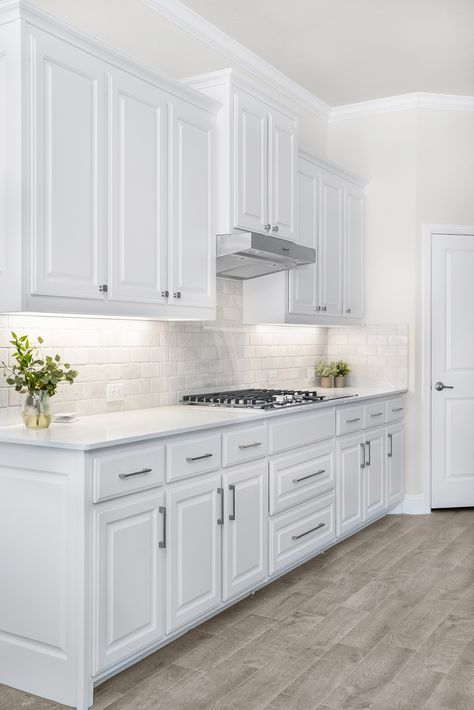 White Cabinets With Silver Handles, White Kitchen Chrome Handles, Upper Kitchen Cabinet Ideas Layout, White Raised Panel Kitchen Cabinets With Black Hardware, White Cabinet Silver Handles, White Kitchen Cabinet Knobs, White Kitchen Cabinets With Silver Pulls, Kitchen Nobs Ideas, Kitchen Cabinets Handles And Knobs Ideas