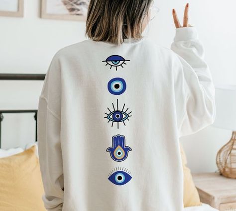 Evil Eye Sweatshirt All Seeing Eye Witchy Sweatshirt Preppy Sweatshirt Hamsa Sweatshirt Trendy Clothes Aesthetic Clothes Manifestation Top T shirt #tshirt t-shirt #t_shirt t shirts #tshirts t-shirts #t_shirts T shirt design #tshirtdesign T-shirt designs #t_shirtdesign T shirts designs #tshirtsdesigns 2.277 Evil Eye Embroidery Design On Shirt, Evil Eye Clothes, Cool Shirts Aesthetic, Evil Eye Clothing, Etsy Sweatshirts, Cool Sweatshirts, Sweatshirt Preppy, Eye Hoodie, Preppy Sweatshirts