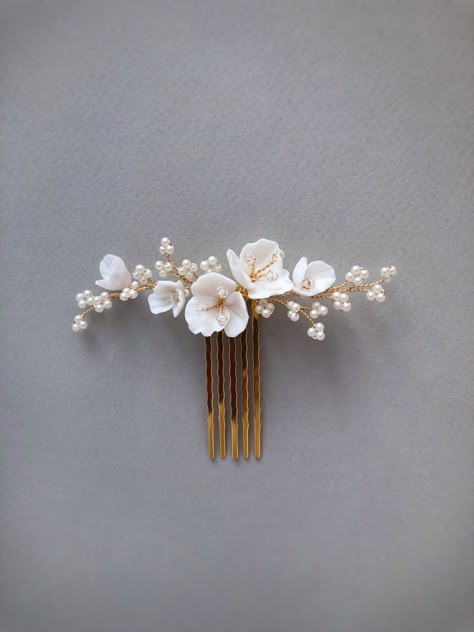 Delicate and stunning floral comb is crafted with handmade Porcelain flowers and small matte beads. Use this flower hair comb to accentuate an updo or add a whimsical touch to loose waves. So small the comb is well attached and holds even on short hair (if necessary, it can be fixed with a bobby pin). This bridal hair piece is versatile and can complement any wedding gown design. Available on silver and gold wire. Length: 9 cm ( 3.5 inch) If you like this bridal hair comb, I recommend that you s Floral Hair Pins Hairstyles, Tropical Wedding Hair Piece, White Flower Hair Accessories, Bridal Floral Hair Piece, Wedding Hair Decoration, Hair Accessories Bride, Bridal Hair With Comb, Gold Hair Piece Wedding, Hair Pieces For Wedding