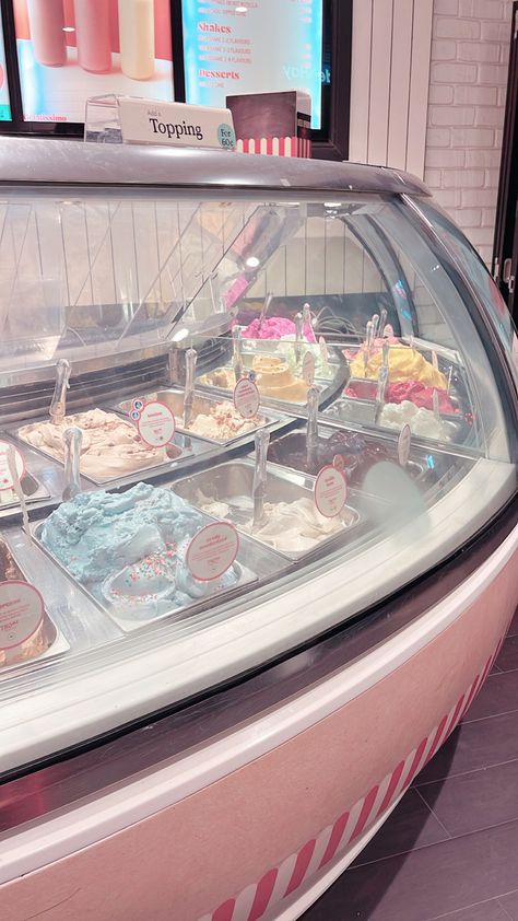 Pastel ice cream parlour with many flavours of ice cream in a glass case Ice Cream Maker Aesthetic, Japan Ice Cream Shop, Ice Cream Parlour Aesthetic, Old Fashion Ice Cream Shop, Cute Shop Aesthetic, Coffee And Ice Cream Shop Design, Pink Ice Cream Aesthetic, Japanese Ice Cream Shop, Beach Ice Cream Shop