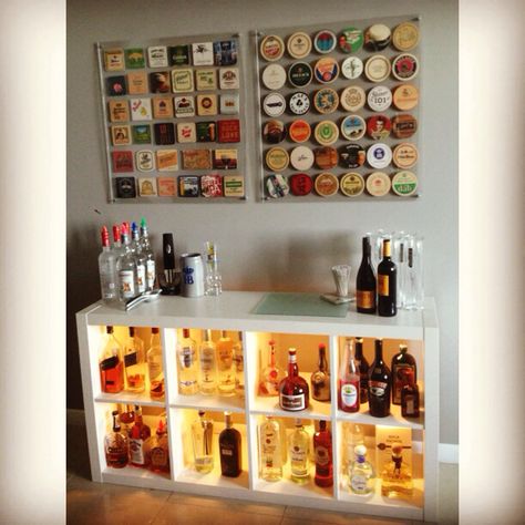 My Apartment Bar! Coasters framed between sheets of Acrylic from Home Depot and with washers/bolts to give space from the wall. Ikea Dioder lights added to Expedit shelf! #ikea #ikeahacks #apartmentideas project by @joelyblanton Bar Coaster Crafts, Beer Mat Display, Framed Coasters, Brewery Stickers, Beer Coaster Art, Beer Coasters Diy, Beer Crafts Diy, Coaster Display, Beer Crafts