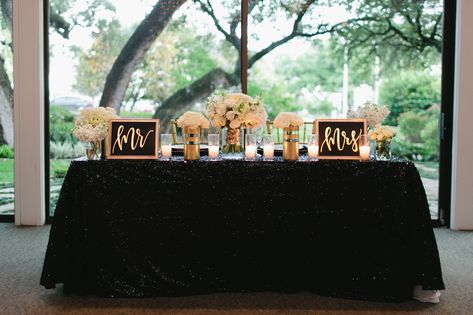 Bethany and Kevin sat at a sweetheart table set against the oversize window backdrop, where they exchanged vows. It had black linens topped with white flower arrangements and gold-framed signs with "Mr." and "Mrs." in whimsical gold calligraphy. Black And Gold Sweetheart Table Wedding, Wedding Brunch Decorations, Black And Gold Banquet, Hi Evelyn, Black And White Sweetheart Table, Gold Sweetheart Table, Wedding Entry Table, Banquet Table Decor, Bridesmaid Brunch Invitations