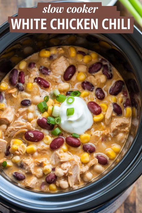 White chicken chili in a slow cooker topped with sour cream and green onions. Crockpot Ideas With Chicken, Crock Pot Heart Healthy Meals, White Chicken Chili With Black Beans, Healthy White Chicken Chili Slow Cooker, White Chicken Chili Slow Cooker With Rotisserie Chicken, White Chilli Chicken Crockpot, White Bean Chicken Chili Stovetop, Crock Pot Lunches For Work, White Chicken Chili Slow Cooker Easy