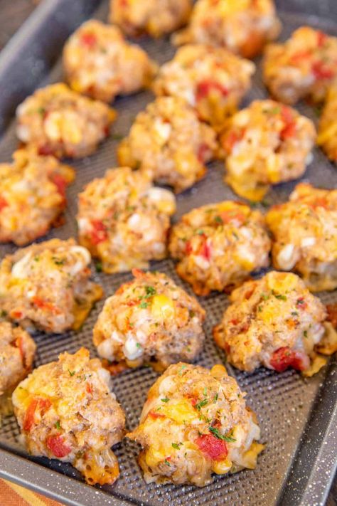 Rotel Cream Cheese Sausage Balls - a kicked-up version of our famous sausage balls! Only 5 ingredients - sausage, Bisquick, cream cheese, Rotel diced tomatoes and green chiles, and Mexican cheese blend. Can make in advance and freeze for a quick snack later. Great for breakfast, brunch, lunch, an appetizer at parties, and afternoon snacks. Whip up a batch ASAP! Total Cream Cheese Sausage Balls, Totem Cream Cheese Sausage Balls, Title Cream Cheese Sausage Balls, Saturday Football Food, Mexican Sausage Balls, What To Make With Pork Sausage, Rotes Cream Cheese Sausage Balls, Cream Cheese Food Recipes, Sausage Balls With Rotel