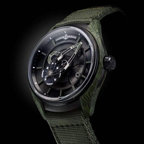 At last week's @watchesandwonders Shanghai, we witnessed the unveiling of @ulyssenardinofficial's Freak [X Ops]. With a black DLC titanium case, bezel and crown, and khaki green and black carbon fibre composite flanks, the Freak [X Ops] has no dial and no hands. Find out more at the link. Marine Chronometer, Military Aesthetic, Carbon Fiber Composite, No Hands, Irregular Patterns, Ulysse Nardin, Watch Box, Vibrant Green, Damascus Steel