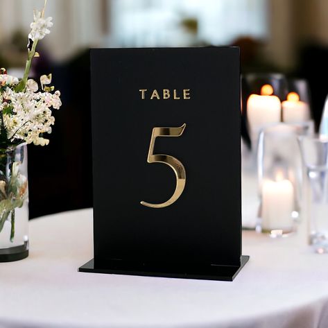 Our acrylic table numbers are perfect for elevating your table decor. Made from high-quality acrylic, these numbers boast durability and elegance in equal measure. Their minimalist design ensures they blend seamlessly with any theme, while adding a touch of modern sophistication. Perfect for weddings, birthday parties, and other special events, our acrylic table numbers not only enhance the aesthetic appeal of your tables, but also streamline organization for guests seating. With easy-to-read di Reception Table Number Ideas, No Chargers Wedding Table, Black Wedding Table Numbers, Black Wedding Accents, Black Table Numbers Wedding, Black Gold White Wedding, Unique Wedding Table Numbers, Black White Gold Wedding, Wedding Table Number Ideas