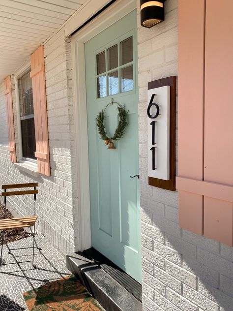 Funky Shutters Exterior, Flamingo Feather Behr, Pink And Green Exterior House, Pink Shutters On House, Door And Shutter Color Combinations, Brick Ranch House Exterior, Painted Brick Ranch House, Shutters Colors, Colorful Shutters