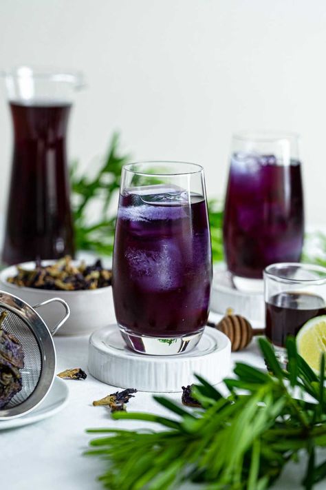 Butterfly pea tea or blue tea is a herbal drink made from two very simple ingredients - butterfly pea flowers and boiling water. This drink can be enjoyed either hot or cold and you can add more flavor to it with a bit of honey and a squeeze of lime! #ButterflyPeaTea #ButterflyPeaFlowertea #BlueTea #BlueTernateTea #BlueTernate #EdibleFlowerRecipe #EdibleFlowerTea #EdibleFlowerDrink #FlowerTea #FlowerDrink #HerbalDrink #Healthydrink #BlueDrink # ThaiDrink #NamAnchan #น้ำอัญชัญ #อัญชัญมะนาว Porch Drinks, Butterfly Pea Flowers, Flower Recipes, Herbal Drink, How To Make Butterfly, Edible Flowers Recipes, Butterfly Pea Tea, Butterfly Pea Flower Tea, Seasonal Eating