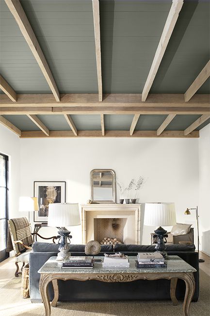 A modern neutral palette living room with high wood panelled ceiling painted in a dramatic gray. Dark Gray Paint, Painted Wood Ceiling, Trashy Y2k Bedroom, Painted Ceiling Beams, Dark Gray Paint Colors, White Ceiling Paint, Painted Beams, Ceiling Paint Colors, Beams Living Room