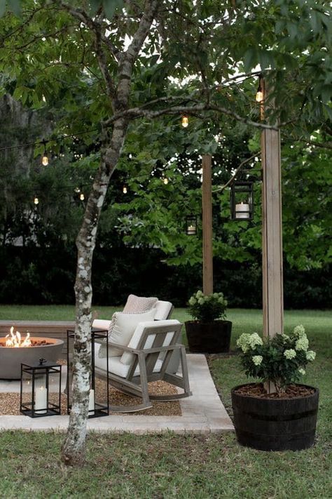 Easy and Cheap DIY Outdoor Lighting Idea. Patio makeover with backyard string lights and DIY planter posts to hang them. Outdoor Patio Ideas Small Spaces With Fire Pit, Backyard Patio And Garden, Outdoor Sitting Area Under Tree, Stepping Stones Fire Pit, Canopy Over Patio, Pavered Fire Pit Area, Farmhouse Firepits Backyard Ideas, Townhouse Backyard Garden, How To Landscape A Square Area