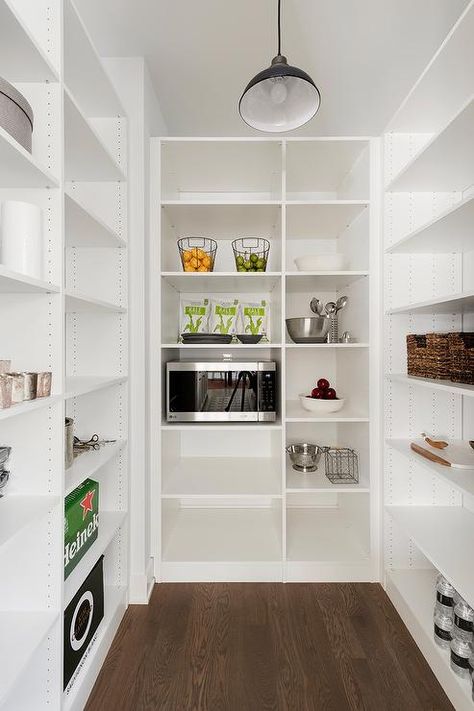 Sleek walk-in pantry with white modular shelves delivers plenty of storage space for an organized and well-styled design. Narrow Walk In Pantry, Basement Pantry, Pantry Dimensions, Pantry Organization Ideas Shelves, Pantry Design Ideas, Minimalist Pantry, Laundry Remodel, Walk In Pantry Ideas, White Kitchen Pantry