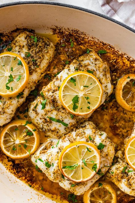 Easy Oven Baked Cod Recipe (Lemon Butter and Herb) Cod In Oven, Baked Cod Recipes Oven Easy, Baked Cod Recipes Oven, Cod Recipes Baked, Baked Hake Recipes, Cod Recipes Oven, Hake Recipes, Oven Baked Cod, Parmesan Crusted Zucchini