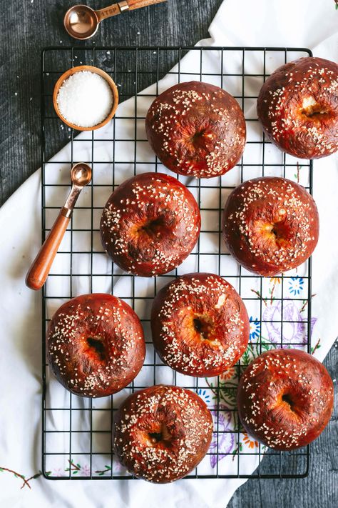 an overhead shot of 8 pretzel bagels on a black wire cooling rack Pretzel Bagels, The Practical Kitchen, Pretzel Dough, Plain Bagel, Baking Soda Bath, Practical Kitchen, Bagel Recipe, Cooling Rack, Loaf Cake