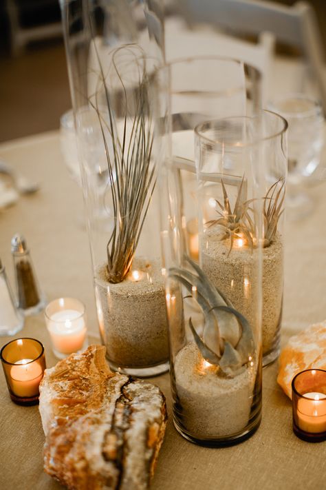 vase centerpieces - photo by Our Love is Loud http://ruffledblog.com/colorado-wedding-with-earth-tones Simple Beach Centerpieces Wedding, Beach Boho Centerpieces, Sea Grass Centerpiece, Boho Beach Centerpieces Wedding, Wedding Centerpieces Non Floral, Water Wedding Decor, Fall Beach Wedding Centerpieces, Earth Tones Wedding Decor, Sand Centerpieces Wedding