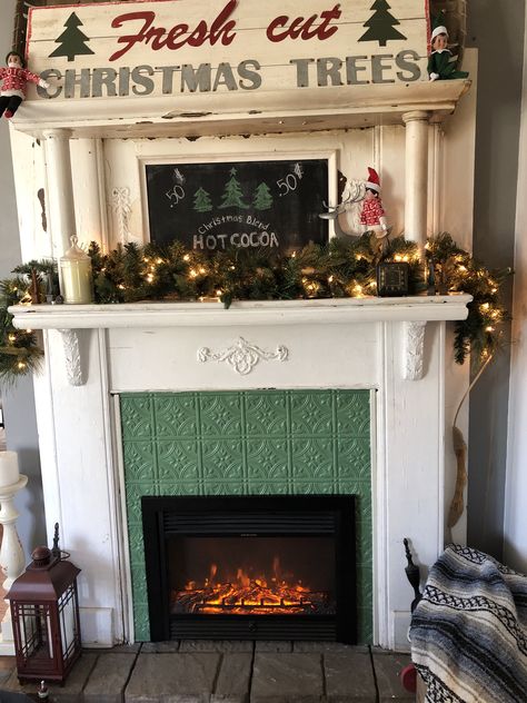 Antique mantel, electric fireplace insert plus faux tin tile from amazon painted the best vintage green! Faux Fireplace Electric Heater, Vintage Mantle With Electric Fireplace, Dining Room Faux Fireplace, Painted Antique Fireplace Mantel, Antique Mantle With Electric Fireplace, Faux Fireplace With Electric Insert, Fireplace Inserts Ideas, Fireplace Insert Ideas Decor, Antique Mantle Fireplace