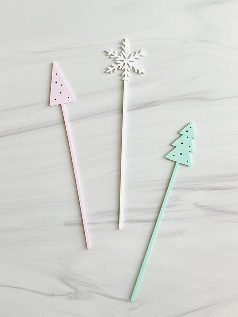 "Claim your cup with a cute little Christmas drink stirrer! Perfect for parties, intimate events, and the holidays, these unique drink tags make the most adorable embellishment to your cocktails. Simply pop them into a champagne flute or wine glass and use them as place cards or party favors for your guests! Set of 12 // 4 stirrers per design Measurements: Approximately 1\" W x 6.5\" H  Material: Acrylic Safe to use in hot and cold beverages Care instructions: Kindly hand wash with warm water an Sticks Christmas Tree, Christmas Drink Stirrers, Intimate Events, Drink Stirrer, Christmas Tree Snowflake, Candle Party Favors, Christmas Drink, Drink Marker, Unique Drink