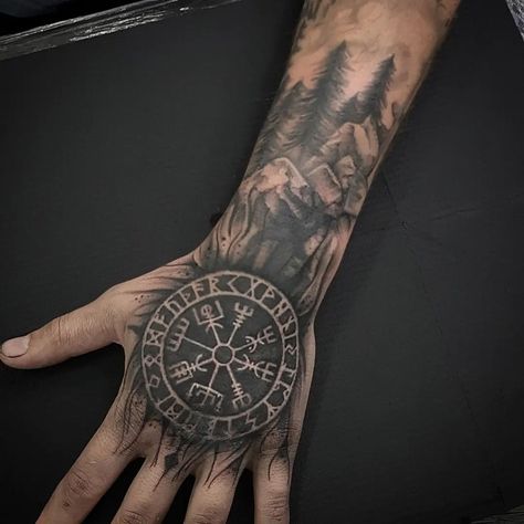 Viking Tattoos: Unleash Your Inner Warrior With 30+ Unique Tattoos With Meaning Viking Compass Hand Tattoo, Hand Forearm Tattoos For Guys, Nordic Hand Tattoos For Guys, Viking Compass Tattoo Men, Odin Hand Tattoo, Nordic Tattoo Ideas For Men, Nordic Tattoo Men, Viking Tattoos For Men Warriors, Viking Head Tattoos For Men