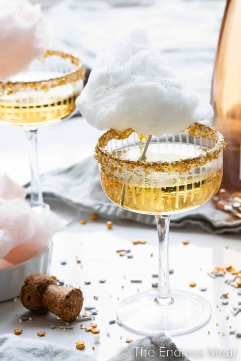 This cotton candy champagne is bubbly, sweet, and perfect for parties! It's sparkling wine served in a sprinkle-rimmed glass, then topped with a cloud of cotton candy. It'll take your party to the next level, and it's ready in minutes! #theendlessmeal #cocktail #drinks #cottoncandy #champagne #celebration Nye Champagne, Champagne Recipes, Maple Cotton Candy, Cotton Candy Drinks, Cotton Candy Cocktail, Champagne Recipe, Sweet Champagne, Cotton Candy Champagne, Cocktail Party Decor