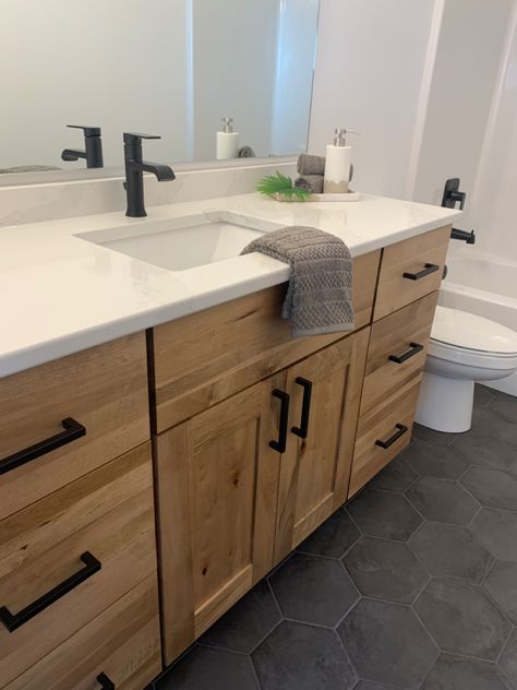 Light Oak Floors Grey Cabinets, Wood Vanity White Countertop, Natural Wood Bathroom Cabinets Modern, Black White Natural Wood Bathroom, White Oak Cabinet Bathroom, Oak Vanity Black Hardware, Re Stain Bathroom Vanity, Light Wood Bathroom Vanity Dark Floor, Black White Oak Bathroom