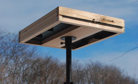 A wooden tray bird feeder is installed on the top of a pipe bird feeder stand. Large Bird Feeders To Build, Tray Bird Feeder Diy, Diy Bird Feeder Easy Wood, Bird Platform Feeder Diy, Bird Feeder Platform, Bird Feeder Tray Platform Diy, Platform Bird Feeder Diy, Diy Bird Feeding Station, Diy Bird Feeder Wooden