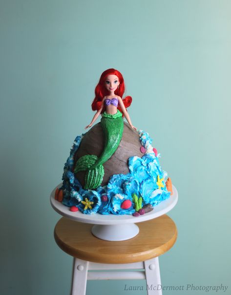 This is a Ariel barbie cake that I made for my daughters 5th birthday. This is a chocolate cake with a white chocolate strawberry ganache filling and than covered and decorated with a vanilla buttercream. Ariel Barbie Cake, Ariel Barbie Birthday Cake, Barbie Mermaid Cakes For Girls Birthday, Ariel Barbie, Mermaid Barbie Cake, Mermaid Ombre Cake, Mermaid Fault Line Cake, Strawberry Ganache, Ariel Cake With Doll