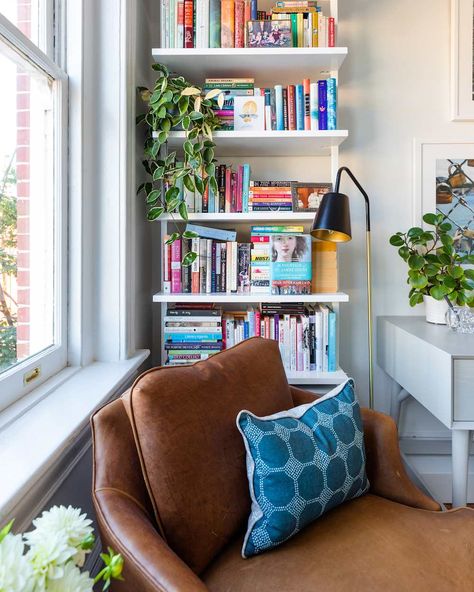 Elisabeth incorporated a pair of her grandmother's reupholstered armchairs into her home, but doesn't keep them both in the same room. "I broke up this pair of armchairs since my home is smaller. The chair in the living room balances the sofa, whereas this chair serves as a cute reading nook in the guest room / office." Credit: <a href="https://www.instagram.com/bettyclicker/">Kate Thompson</a> Plants On Top Of Bookcase, Nook Chair, Reading Nook Chair, Kate Thompson, Condo Apartment, Guest Room Office, Builder Grade, Old Building, Jewel Box