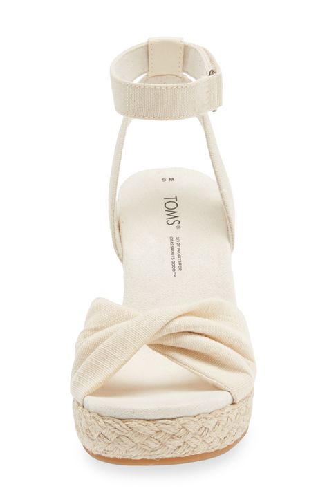 An espadrille-style platform wedge brings earthy texture and stylish height to a warm-weather sandal finished with a twisted toe strap. 3 1/2" heel; 3/4" platform (size 8.5)   3 1/2" strap height   Adjustable ankle strap with hook-and-loop closure   OrthoLite® Eco LT Hybrid insole   TOMS gives a minimum of one-third of its annual net profits to support grassroots efforts, partnering with organizations that boost mental health, increase access to opportunity and end gun violence   TOMS is a Certified B Corporation, which meets standards for verified social and environmental performance, public transparency and legal accountability to create a more inclusive and sustainable economy Costal Grandma Shoes, Cute Fancy Shoes, Cute Wedge Heels, My Wishlist Ideas, Cute Wedges Shoes, Espadrilles Style, Cute Wedges, Summer Wedges, Sandals Platform