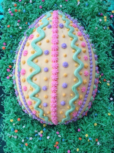 Easter egg cake from a football shaped cake pan. Decorated by: Desirée Correnti Ladd Egg Shaped Cake Ideas, Egg Cake Design, Easter Egg Cake Decorating Ideas, Easter Egg Shaped Cake, Egg Shaped Cake, Easter Egg Cakes, Easter Cake Designs, Pan Images, Easter Cake Decorating