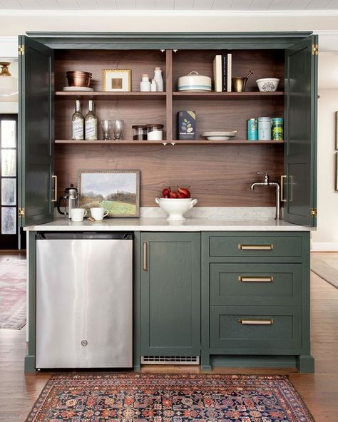 Georgia Hoyler on Instagram: “I adore this lovely green wet bar with stained woodgrain inside! That small vintage rug defines the space and seals the deal for me.…” Hidden Bar Cabinet, Kitchen Wet Bar, Hidden Bar, Small Sink, Small Bar, Basement Reno, Coffee Bar Home, Green Cabinets, Bar Coffee