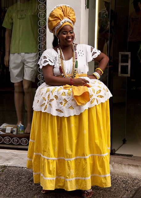 Bahian Woman in Traditional Dress by Marcos Casiano, via Flickr Bahia is one of the 26 states of Brazil, and is located in the eastern part of the country on the Atlantic coast. It is the fourth most populous Brazilian state after São Paulo, Minas Gerais and Rio de Janeiro, and the fifth-largest in size. Bahia's capital is the city of Salvador, or more properly, São Salvador da Bahia de Todos os Santos, and is located at the junction of the Atlantic Ocean and the Bay of All Saints,... Brasil Traditional Clothing, Brazilian Dress Traditional, Brazil Traditional Clothing, Brazilian Traditional Clothing, Traditional Brazilian Clothing, Brazil Traditional Dress, Brazil Costume, Brazilian Clothing, Brazil Clothing