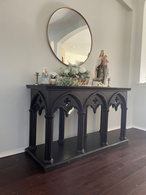 I found the buffet table at a garage sale, but it can be purchased here: https://luxeleatherfurniture.com/shop/living-room/accent-tables/gothic-sofa-table/ The round mirror and all table decor except the statues and rosarg are from At Home. The Mary statues were purchased at a local Catholic store. Rosary can be purchased on Etsy through smallthingsgr8love. Gothic Entryway Decor, Gothic Decor Aesthetic, Goth Table, Gothic Table Decor, Goth Entryway, Gothic Entryway, Gothic Minimalist Decor, Goth Farmhouse Decor, Goth Catholic Aesthetic