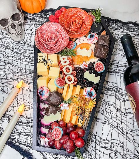 Get inspired with spooky Halloween charcuterie board ideas for a ghoulish feast. Elevate your celebration with creative and delicious treats. Halloween Charcuterie Box Ideas, Pink Halloween Charcuterie Board, Spookuterie Board, Twilight Charcuterie Board, Charcuterie Board Halloween Ideas, Coffin Shaped Charcuterie Board, Halloween Coffin Charcuterie Board, Coffin Charcuterie, Charbooterie Board