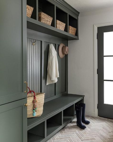 Beautifully design forest green mudroom features a forest green built-in bench boasting shoe shelves and mounted against a forest green beadboard backsplash. Green Drop Zone, Beadboard Mudroom, Green Mudroom, Green Beadboard, Beadboard Trim, Baltimore House, Green Entryway, Transitional Laundry Room, Small Mudroom Ideas