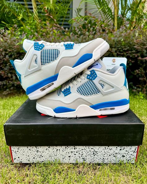 A pair of white Air Jordan 4 sneakers with Military Blue and neutral grey accents. Military Blue 4s, Original Air Jordans, Jumpman Logo, Air Jordan 4 Retro, Loafer Sneakers, Cute Nikes, Bottega Veneta Shoulder Bag, Herringbone Pattern, Air Jordan